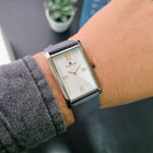 Franklord Ash Luxe rectangular watch on wrist with rose gold Roman numerals and silver dial