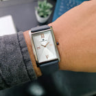 Franklord Ash Luxe rectangular watch worn on wrist with grey strap and clean outfit detail