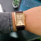 Top view of Champagne Gold rectangular Franklord watch with gold dial and maroon strap