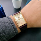 Champagne Gold Franklord watch on wrist highlighting rose gold case and maroon strap