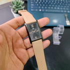 Angled hand-held view of the Franklord Dusky Royale showing rose gold numerals and glossy black dial