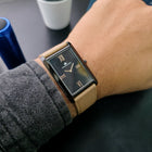 Side view of Franklord Dusky Royale rectangular watch on wrist, highlighting black case and beige strap