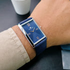 Angled handheld shot of Franklord Ocean Crest blue dial watch with silver case and crown visible