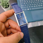 Front view of Franklord Ocean Crest rectangular watch on wrist with deep blue dial and rose gold Roman numerals