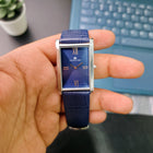Handheld side-angle view of Franklord Ocean Crest with stainless steel case and embossed strap