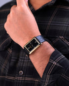 Franklord rectangular gold watch with black dial styled on hand, showcasing elegant wrist pose