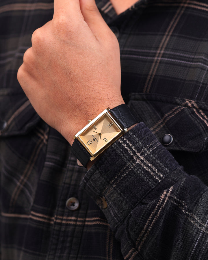 Franklord Royal Gold Heritage watch styled on wrist with formal check shirt, gold dial and black leather strap