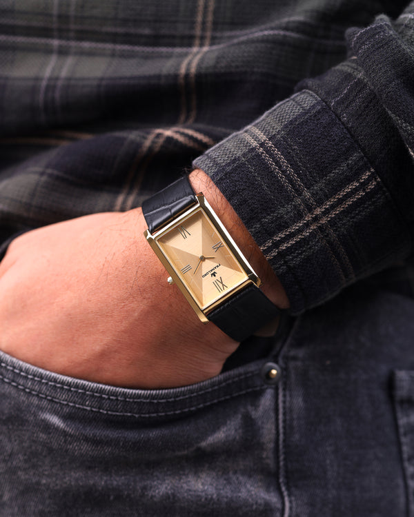 Elegant wrist shot of Franklord Indian Tank Royal Gold Heritage tucked near pocket, showcasing rectangular gold dial