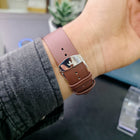 Close-up of butterfly clasp buckle with Franklord crown logo on brown leather strap