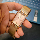 Angled shot of Franklord Champagne Luxe rectangular rose gold watch showing dial shine