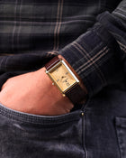 Franklord Royal Gold Heritage rectangular watch styled on wrist, side pocket pose