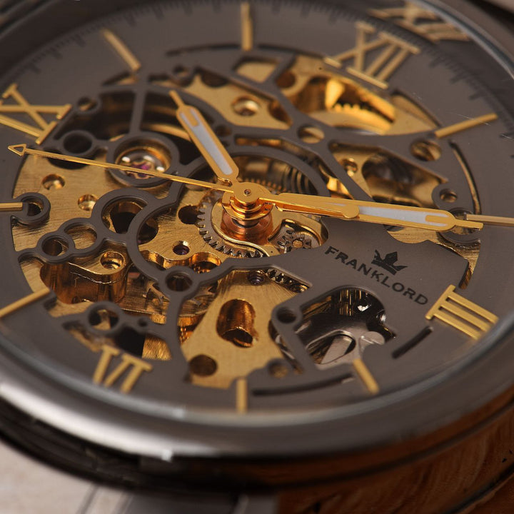 Close-up of Franklord Titanium Shadow Watch skeleton dial with gold accents, exposing the intricate mechanical movement in motion.